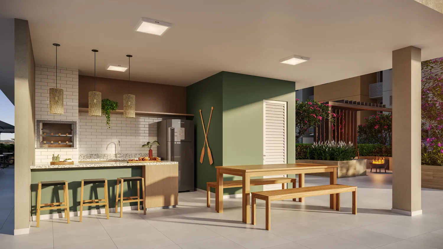 Espaço gourmet com churrasqueira, bancada e mesa comunitária