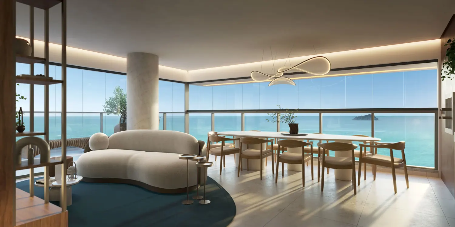 Living com sofá curvo e mesa de jantar diante de janelas panorâmicas para o mar