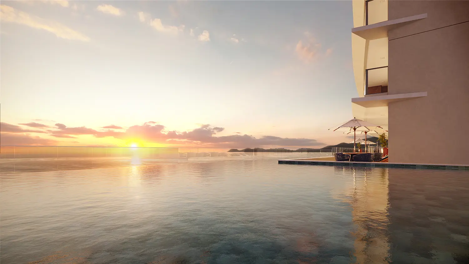 Piscina de borda infinita ao pôr do sol, com o mar ao fundo